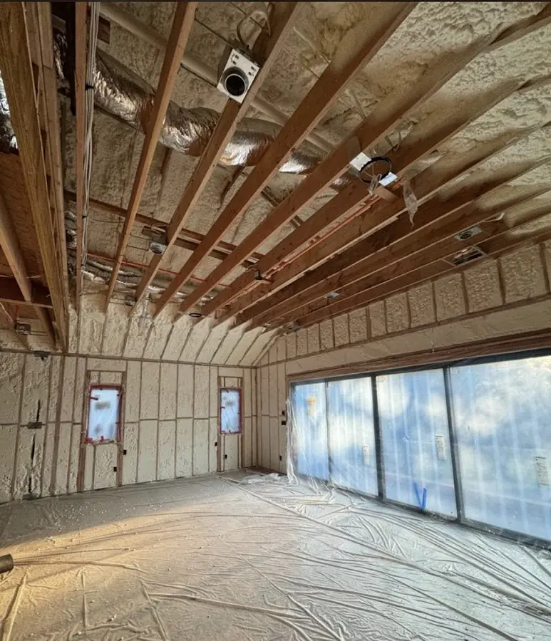 Interior walls and ceiling insulated with spray foam during new construction in Woodmere